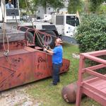 The man on the ground has important work to do, making certain the shackles are tight and securely in place.