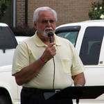 Rev. Haskell Dunn praying for churches