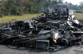 Fire Destroys Camper, Damages Road